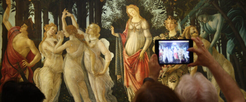 Person taking a picture with their smart phone at museum